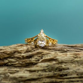 Tiara inspired, Pear shaped diamond and 14k gold engagement ring.